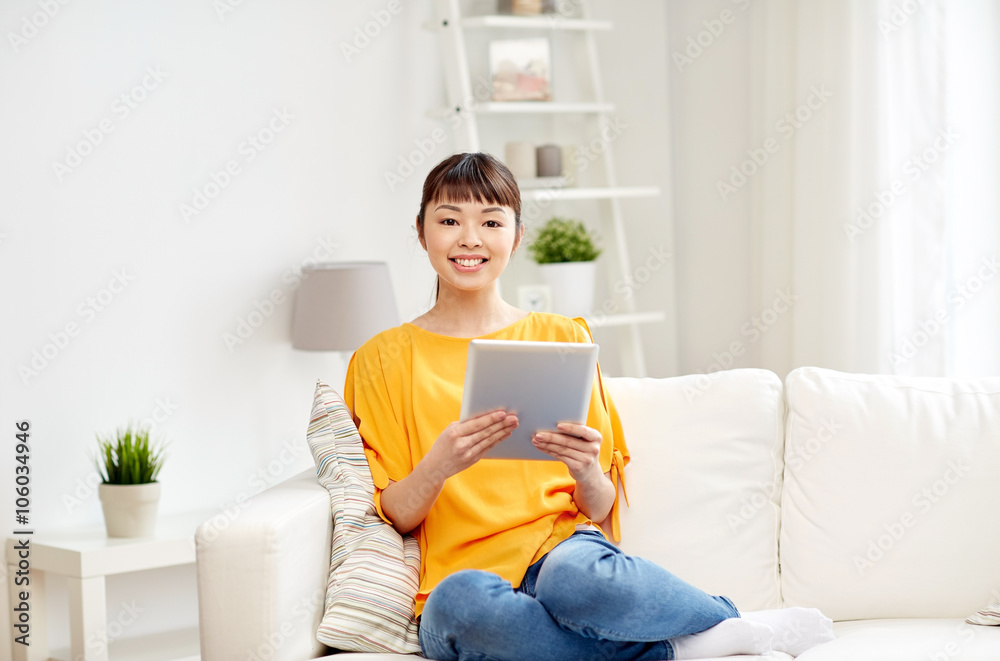 happy young asian woman with tablet pc at home