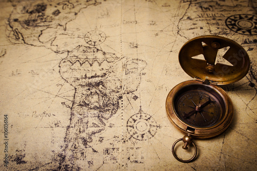 old brass compass on wood table top view