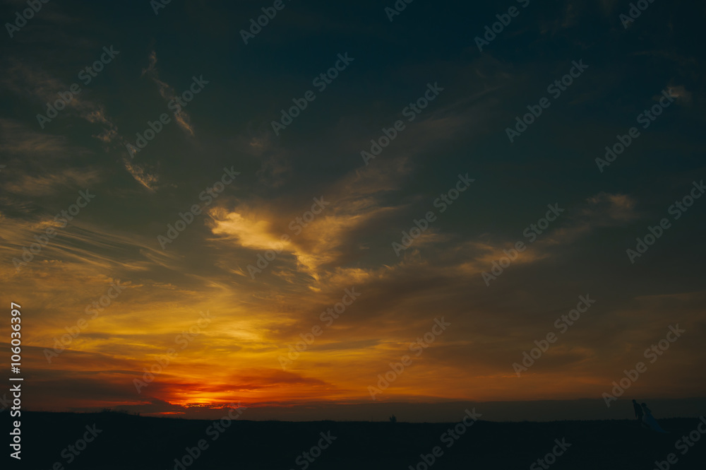Fototapeta premium wedding couple on the background of sunset