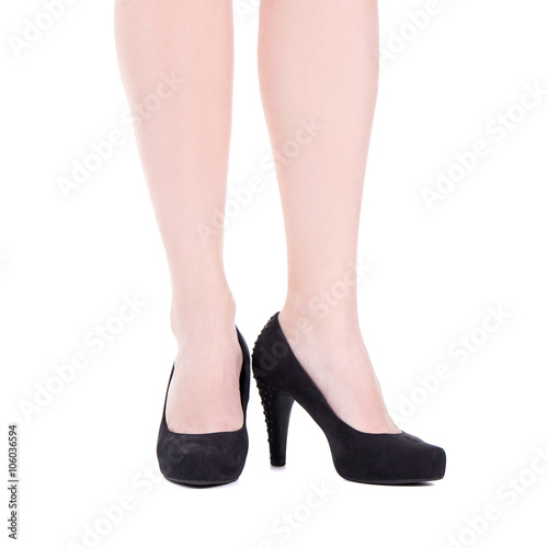 female legs in black shoes on heels isolated over white