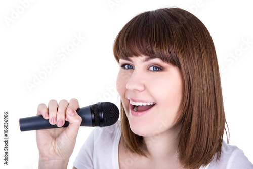 portrait of young beautiful woman singing with microphone isolat
