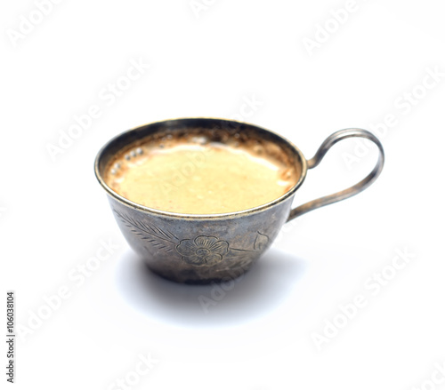 Vintage metal coffee cup with coffee on a white background
