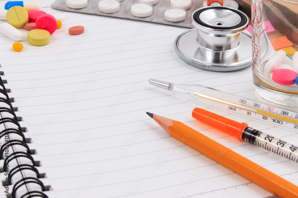 Medical accessories with blank notebook on the wooden table. Medical accessories with blank notebook on the wooden table.