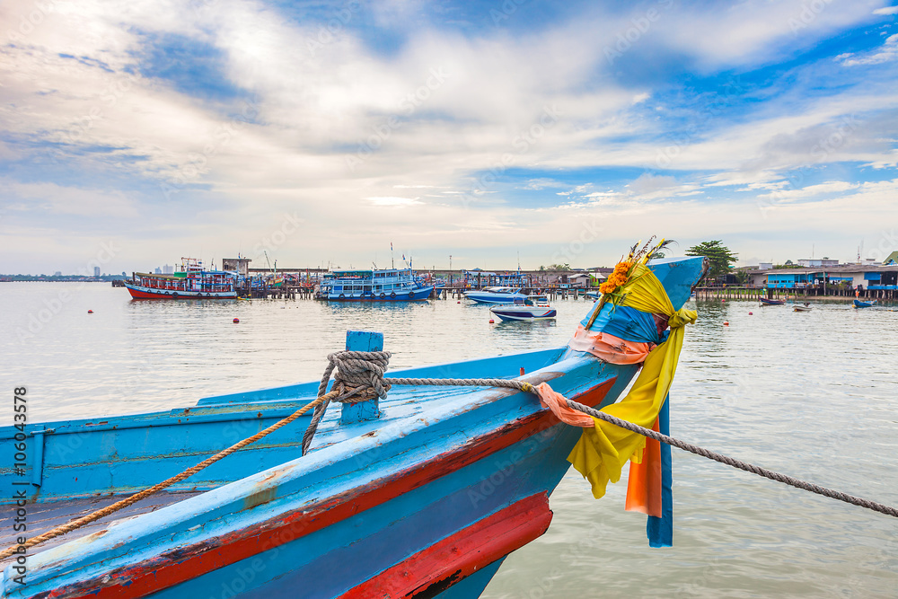 Fototapeta premium fisherman boat docking at pier in the sunset