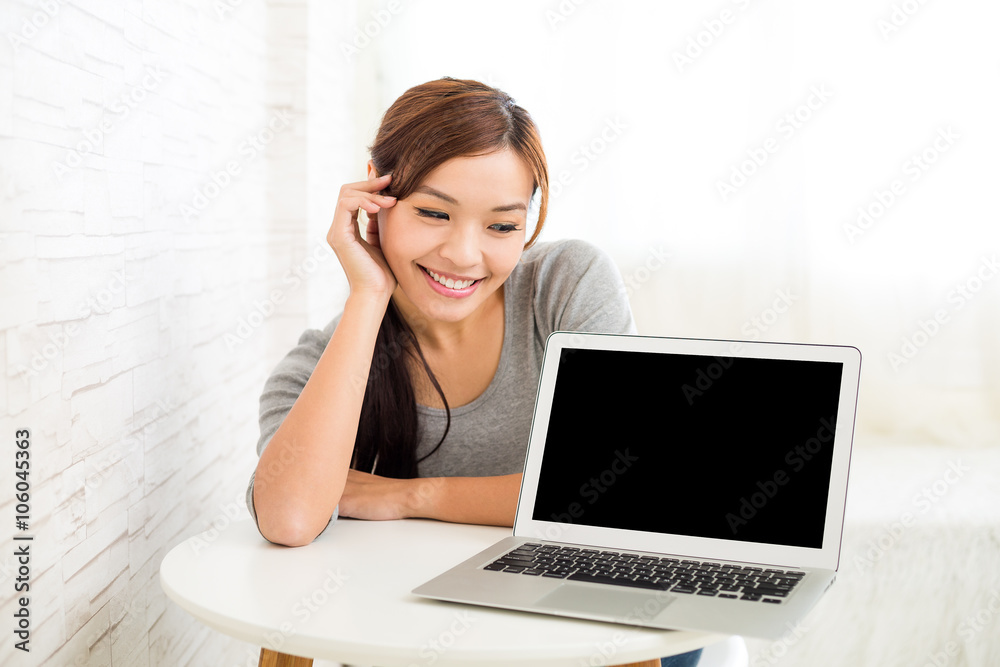 Woman looking at the blank screen of laptop computer Woman looking at the blank screen of laptop computer