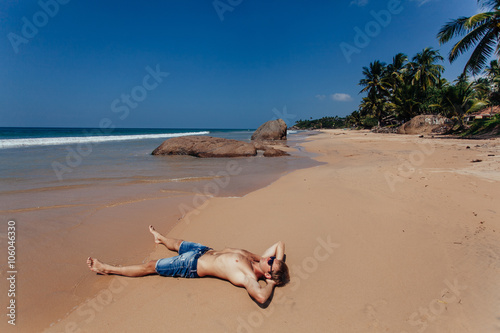 Shirtless male model sunbathing.Top view of  young man relaxing
