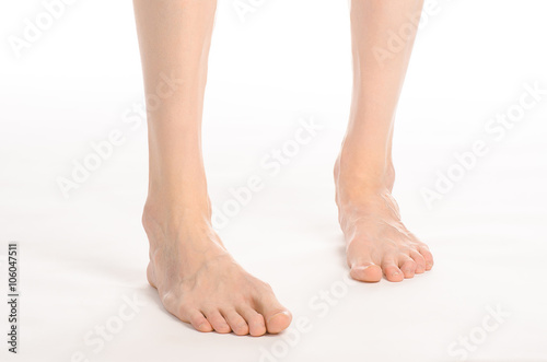 Pedicure and foot care topic: the naked man's legs isolated on white background in studio