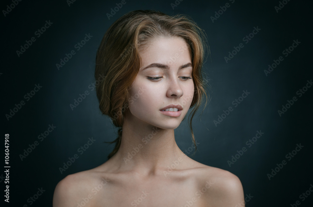 Dramatic portrait of a girl theme: portrait of a beautiful girl with flying hair in the wind against a background in studio Dramatic portrait of a girl theme: portrait of a beautiful girl with flying hair in the wind against a background in studio