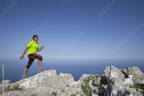 Trail running athlete man training for fitness and marathon living healthy lifestyle outside in beautiful landscape on Big Island.