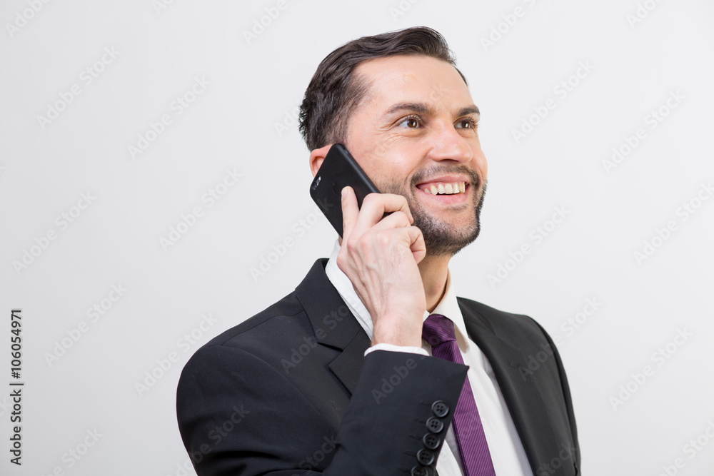 Young business man talks on his phone Young business man talks on his phone