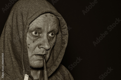 Sepia toned portrait of mature man meditating in darkness