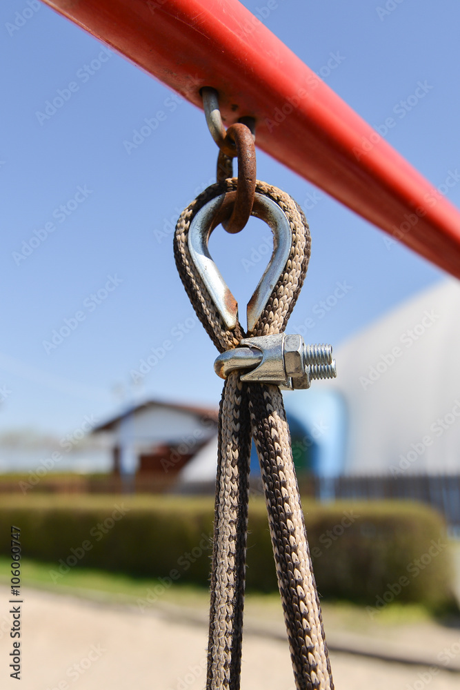 End of swinging rope hang on metal construction in a park. Rough
