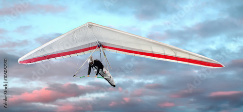 Man hang-gliding at sunset