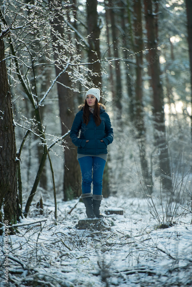 Young woman on a walk in snowy winter