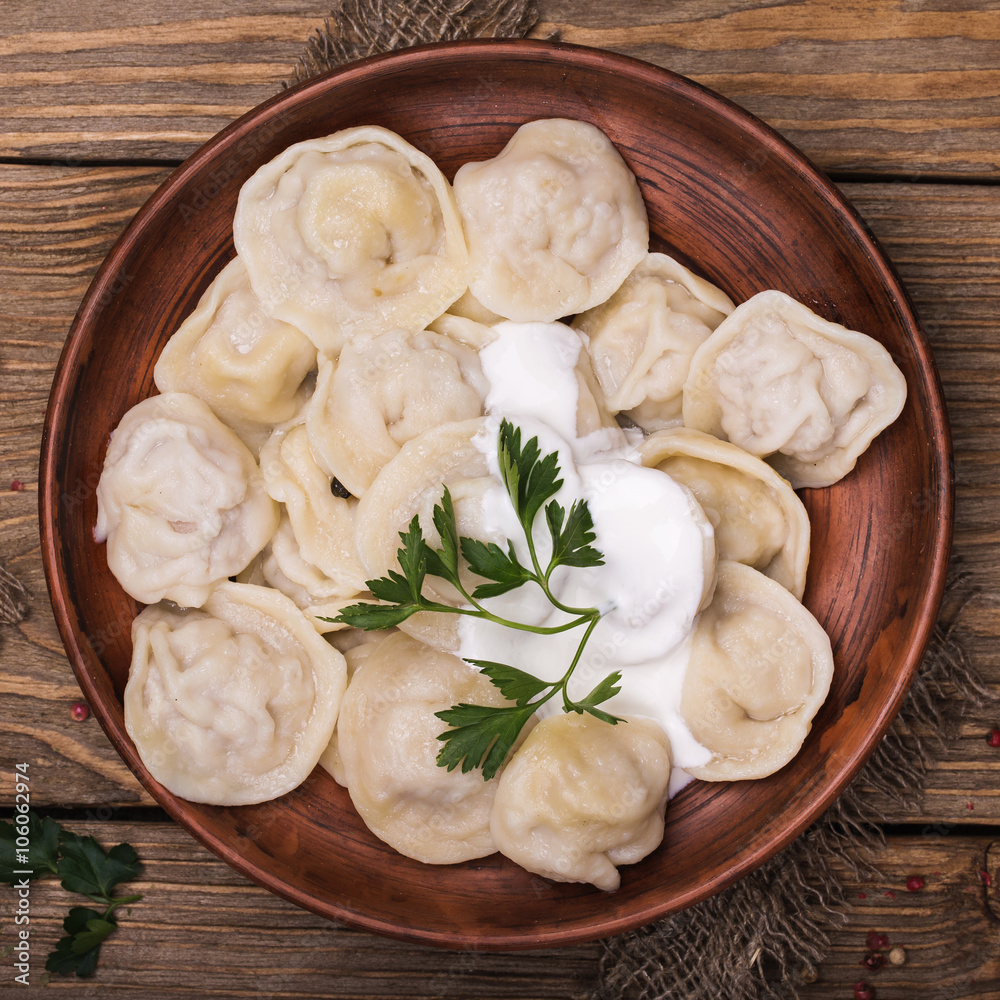 Homemade meat dumplings with sour cream and parsley Homemade meat dumplings with sour cream and parsley