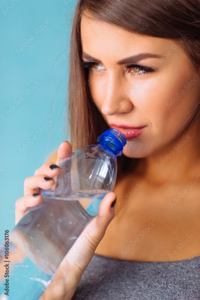 beautiful girl with a bottle of drinking water smiling beautiful girl with a bottle of drinking water smiling