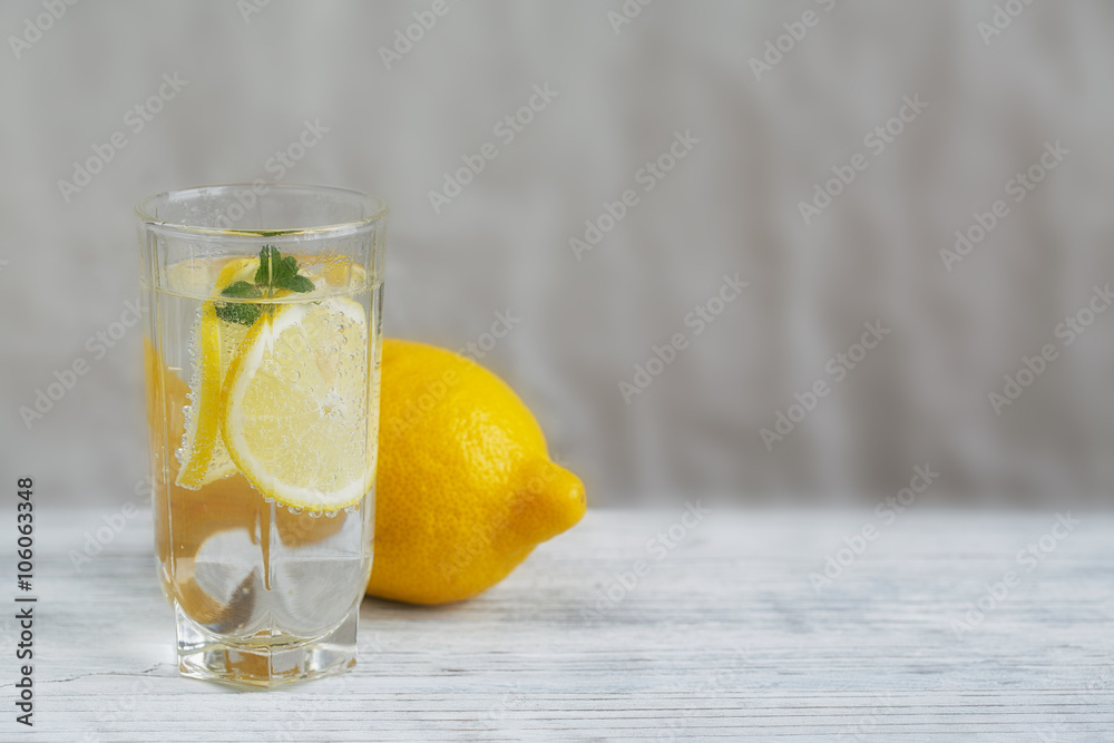 Lemonade with fresh lemon on wooden background Lemonade with fresh lemon on wooden background