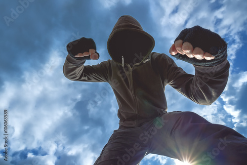 Cuadro en lienzo Violent attack, unrecognizable male criminal kicking and punchin