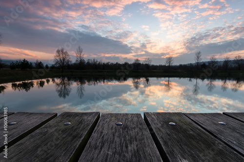Empty wooden table against blurred landscape background © Leszek Czerwonka