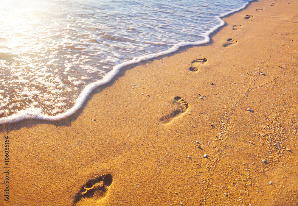 beach, wave and footprints at sunset time beach, wave and footprints at sunset time