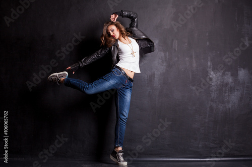 Fototapeta Naklejka Na Ścianę i Meble -  model girl dancing on a black background