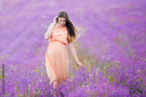 Fototapeta Naklejka Na Ścianę i Meble -  pregnant girl goes in Lavender