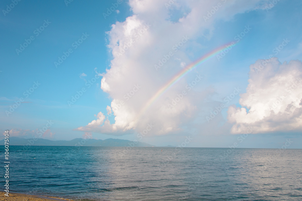 Rainbow over horizon of ocean beach