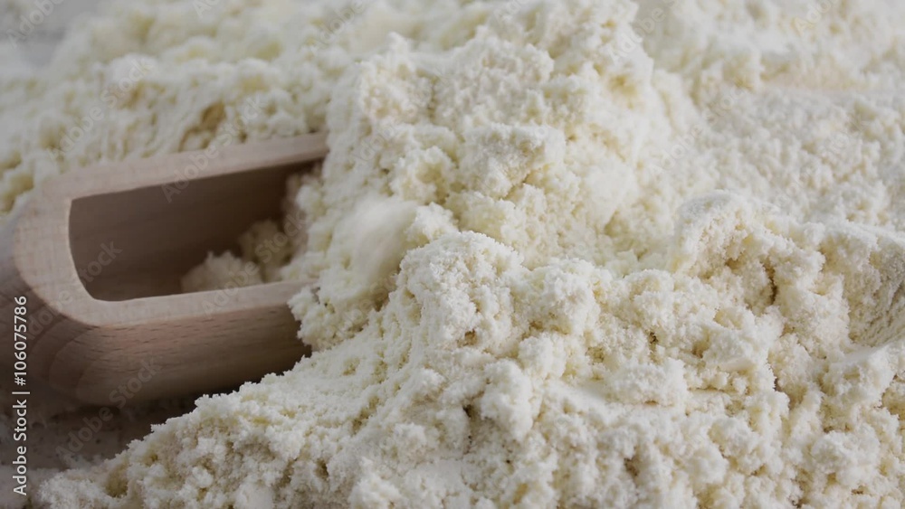 Close up macro of whey protein powder with wooden scoop. Close up macro of whey protein powder with wooden scoop.