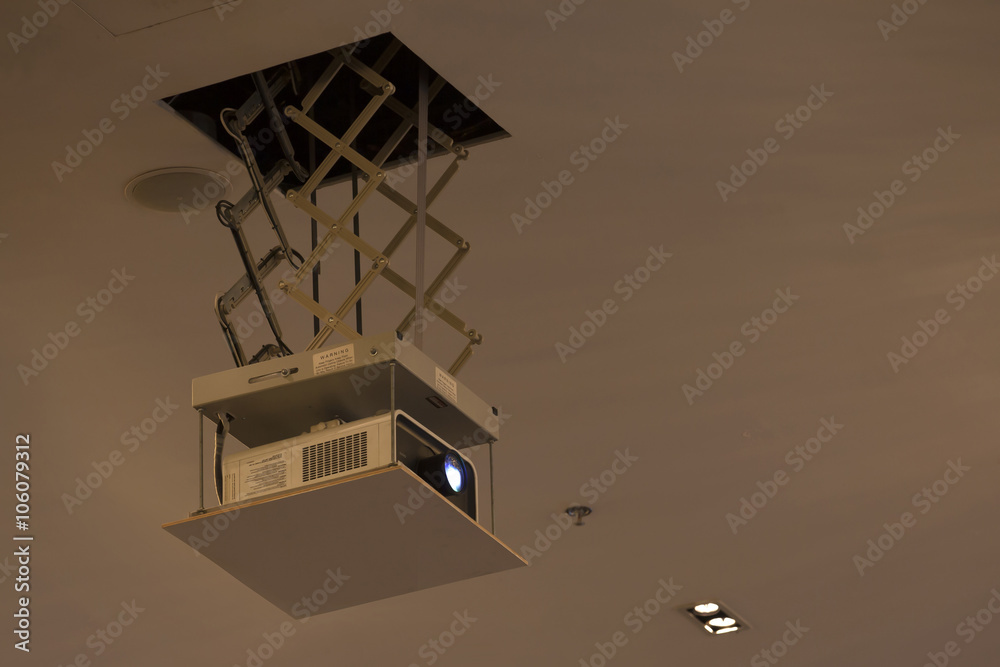 old style overhead projector hanging by zigzag hanger from ceiling