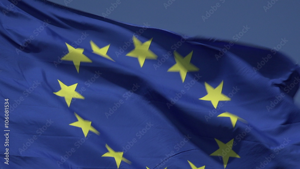 EU flag blowing in wind with blue sky background, European Union EU flag blowing in wind with blue sky background, European Union