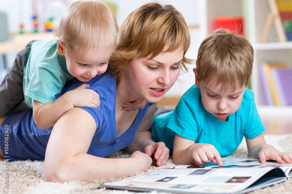 Mother and kids reading book at home Mother and kids reading book at home
