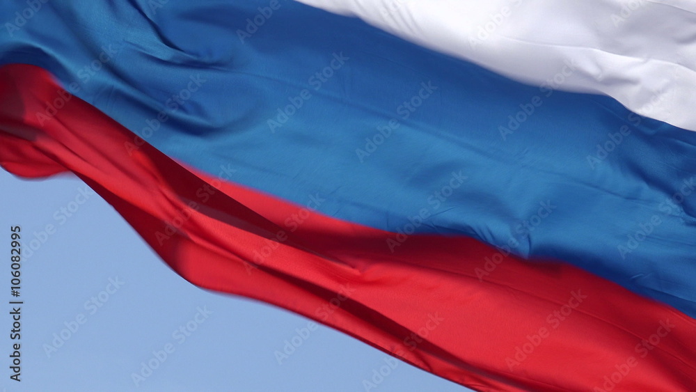 Russian flag blowing in wind with blue sky background, Russia