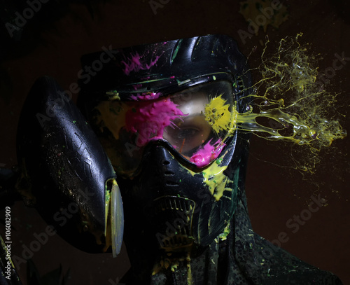 Splashes after direct hit to protecting mask in the paintball game