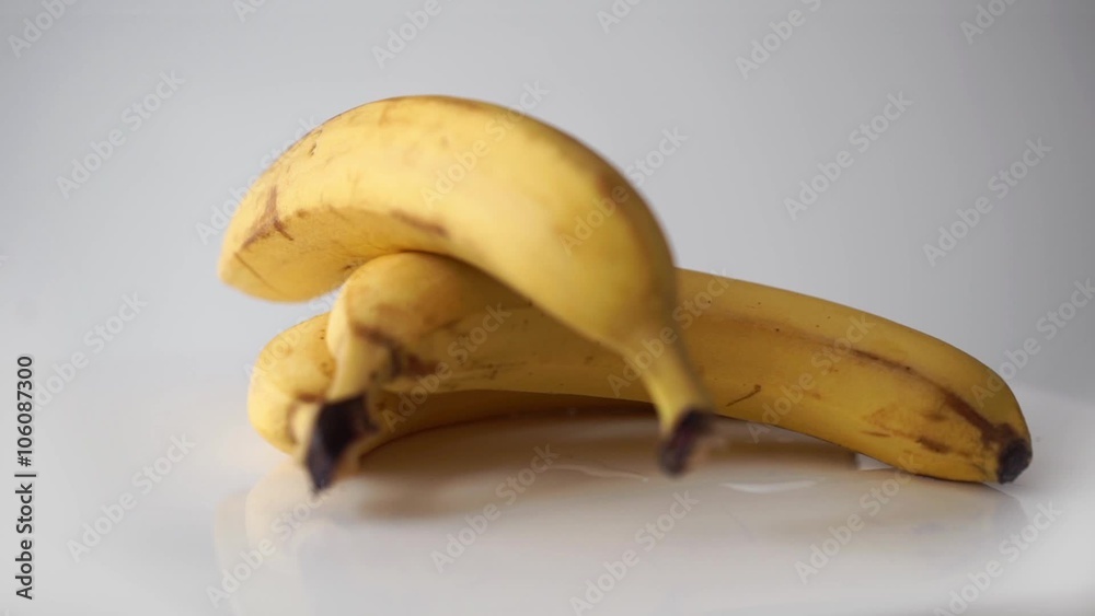 Yellow bananas rotation on white background
