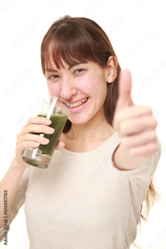 young woman with green vegetable juice