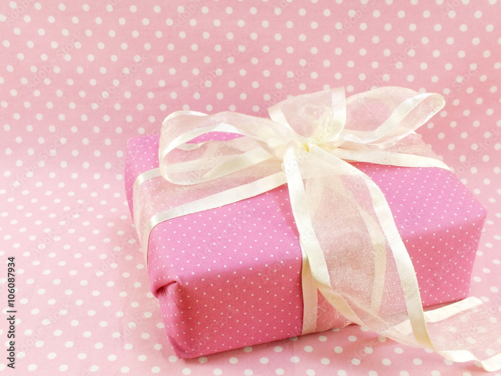 present gift box with pink polka dot background present gift box with pink polka dot background