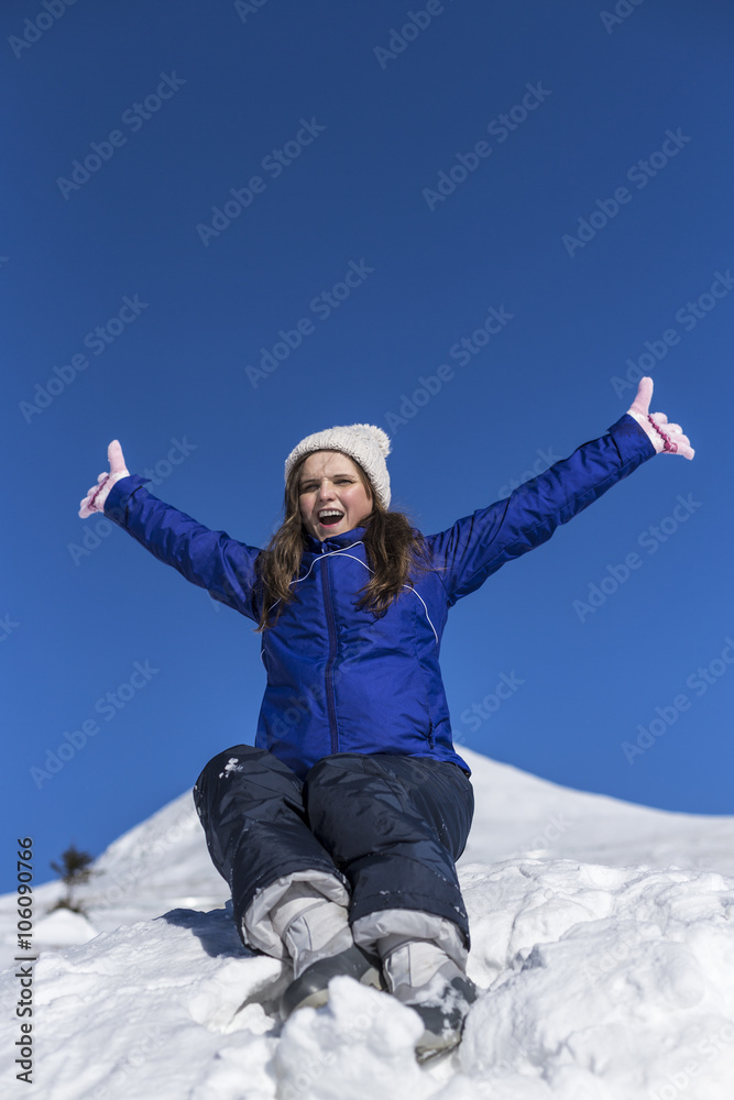 Happy young woman with arms raised on the top of a mountain Happy young woman with arms raised on the top of a mountain