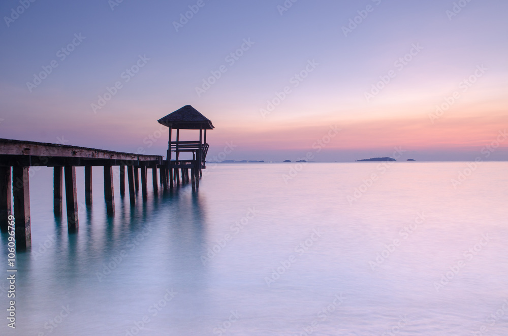 wooden landing with pavilion in the sea.