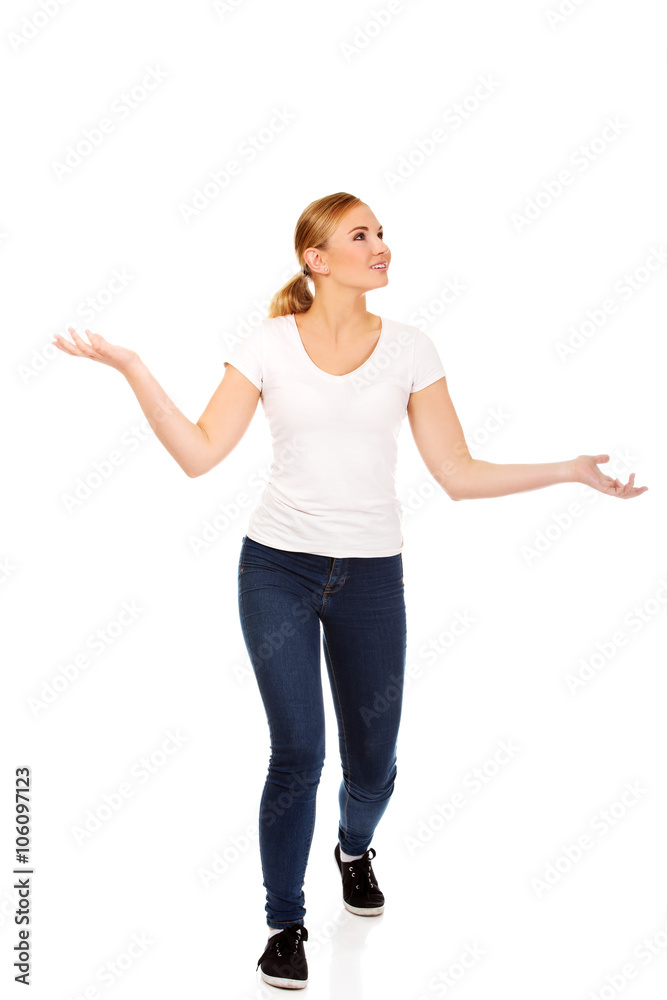 Young woman trying to catch something falling from the sky Young woman trying to catch something falling from the sky