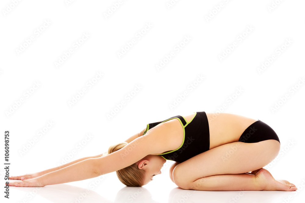 Young woman doing stretching exercise on the floor