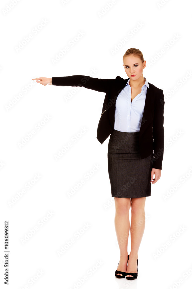 Angry business woman shows get out gesture Angry business woman shows get out gesture
