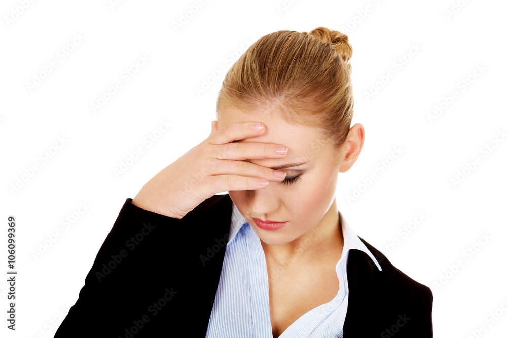 Business woman with a huge headache holding head Business woman with a huge headache holding head