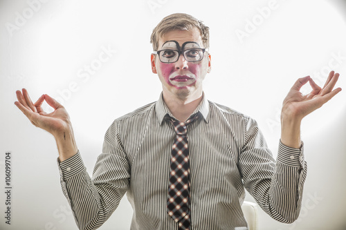 clown MIME in the pose of relaxation dressed in a tie and business shirt