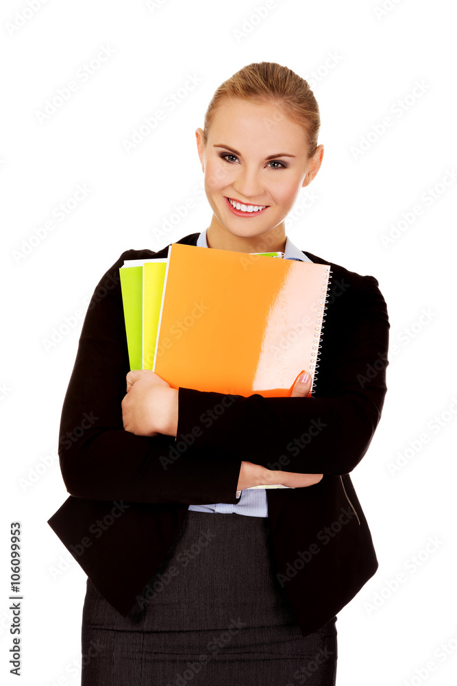 Smiling business woman holding notebooks Smiling business woman holding notebooks