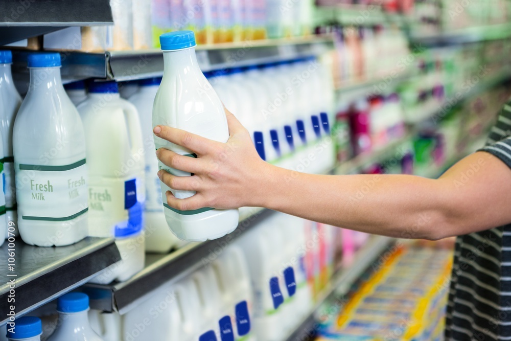 Womans hand holding milk bottle Stock Photo Adobe Stock