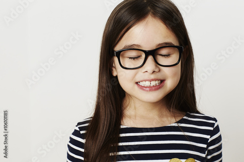 Young girl in spectacles with closed eyes