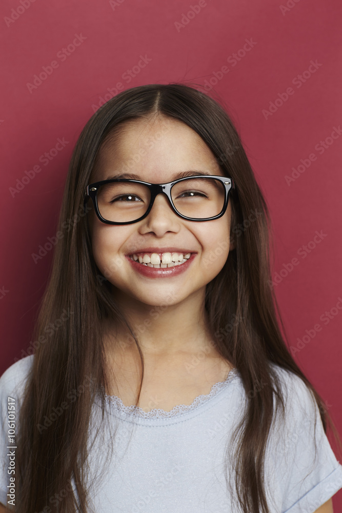 Smiling girl in front of red background, smiling Smiling girl in front of red background, smiling