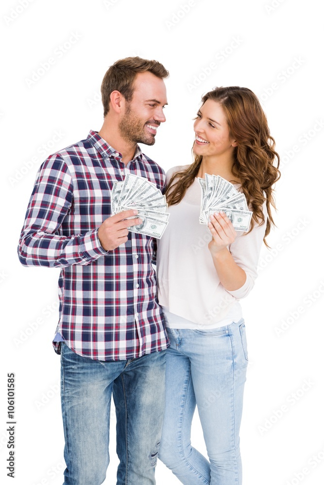 Happy young couple holding fanned out currency notes Happy young couple holding fanned out currency notes