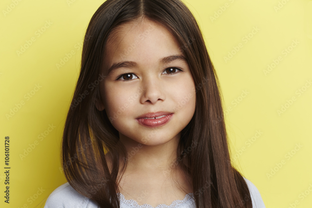 Young girl against yellow background, portrait Young girl against yellow background, portrait