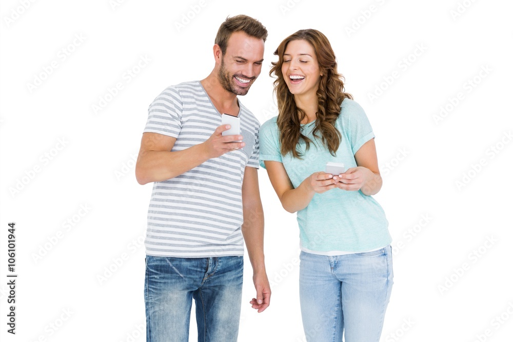 Happy young couple looking at mobile phone Happy young couple looking at mobile phone